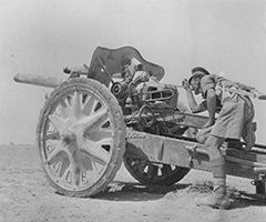 A British soldier inspects a captured German 105mm gun in Gazala 1942