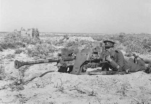 A British soldier inspects a captured German 2.8cm gun in Gazala 1942
