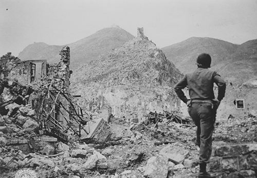 American soldier looks up at Monte Cassino