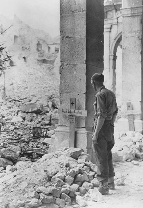 British soldier with German graves in Monte Cassino