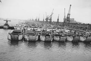 Landing craft massed along the quayside.
