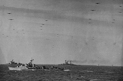 Cruisers wait off the Normandy Coast