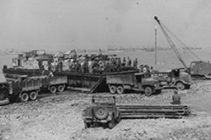 Supplies are unloaded from the Dumb Barge