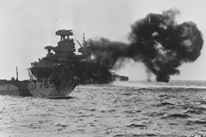 Warship firing on Omaha Beach