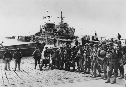 US troops wait to board their transport