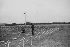 French civilians place crosses at the graves of American soldiers