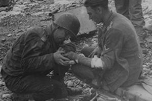 Browse American medical officer treats a wounded German prisoner