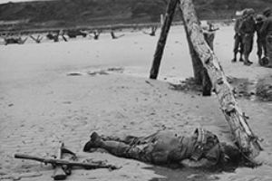 Browse A dead GI lies beside a German Obstacle