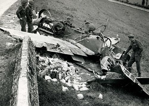 British troops inspect the wreckage of a Messerschmitt