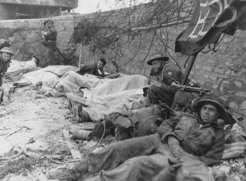 Wounded infantry await evacuation