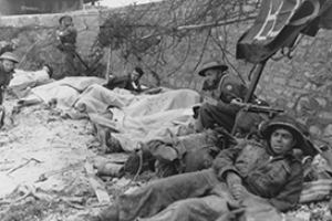 Wounded infantry await evacuation