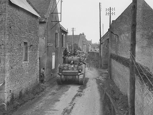 Tanks moving through the narrow streets of Thaon