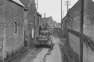 Tanks moving through the narrow streets of Thaon