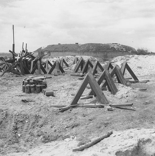 Beach obstacles dumped at the top of the beach