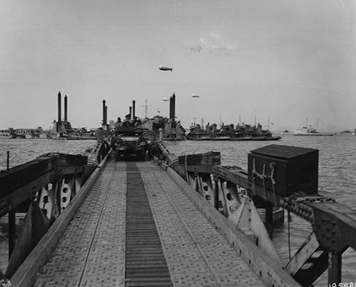 An army vehicle proceeds to Omaha Beach