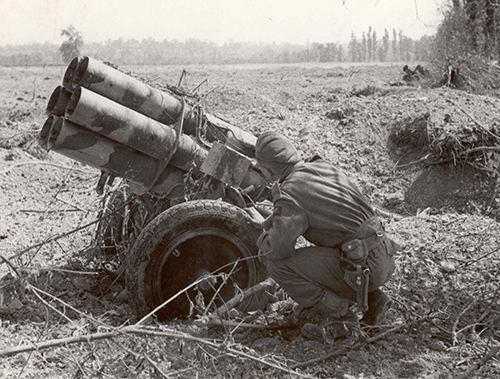 A soldier examines an abandoned German Nebelwerfer