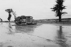 A supply truck negotiates a flooded road.