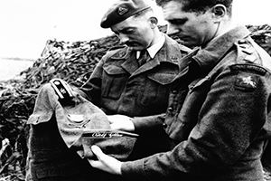 Browse Officers examining the tunic of a corporal in the Adolf Hitler unit