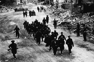 Browse Canadian soldiers escort a group of German prisoners