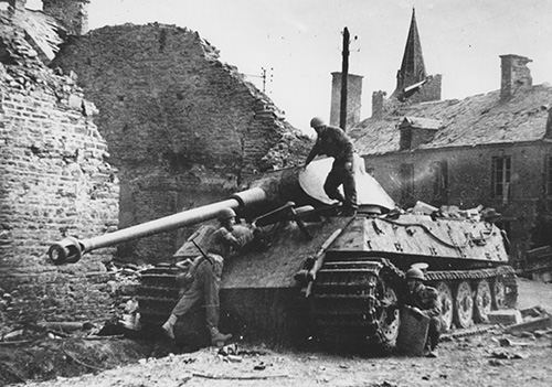 Troops inspect a knocked out King Tiger tank
