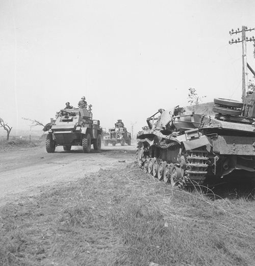 A convoy headed up by a Canadian armoured car