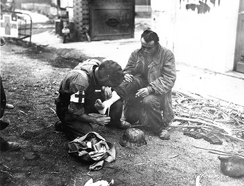 A wounded German soldier recieves medical attention