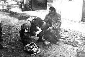 A wounded German soldier recieves medical attention