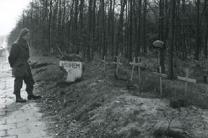 A soldier pauses by temporary graves (BU 4131)