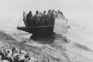 A platoon of American troops land from a naval LCVP