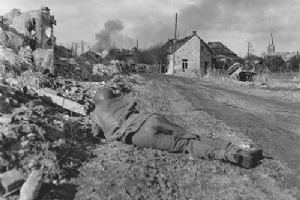 An infantryman takes cover during the bombardment of Goch
