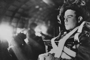 A paratrooper seated in a Dakota aircraft