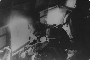 A paratrooper looks out of the window