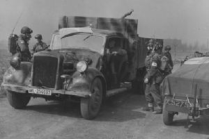 Airborne troops with a requistioned German truck