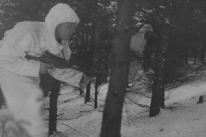 A British Airborne soldier patrols through the woods