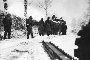 US infantrymen follow a Sherman tank