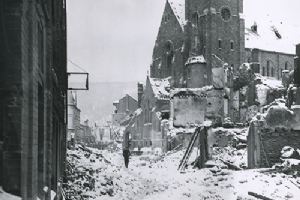 A civilian picks his way through the rubble