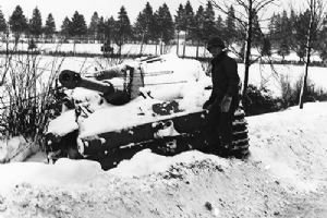 US soldier inspects a knocked out Tiger tank