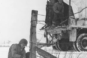 A member of the 4th Armoured Div laying wire
