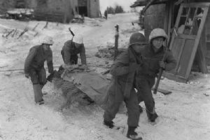 A patrol from 30th Division rescue an injured German soldier