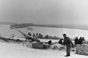 Two 155mm 'Long Tom' Howitzers shell German positions east of Bastogne