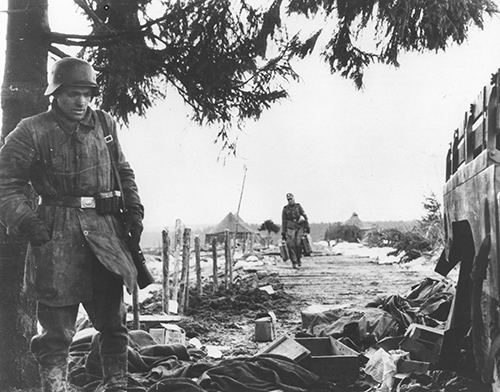 German soldiers examine litter for supplies