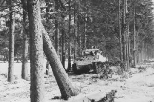 A Sherman moving along a forest road near Bastogne