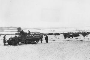 Half-tracks of the 4th Division wait to advance