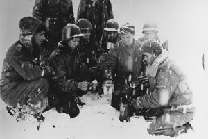 Soldiers heat coffee with a blowtorch