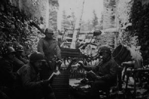 Medics warming up around an oil drum stove