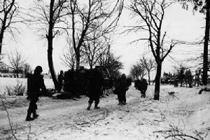 Troops of the 7th Armored Division look over an undamaged German tank