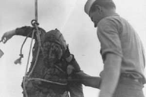 A service man retreieves a Japanese Airman